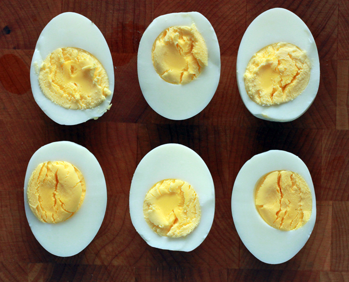 Eggs under pressure cut in half with the yolks facing upwards.
