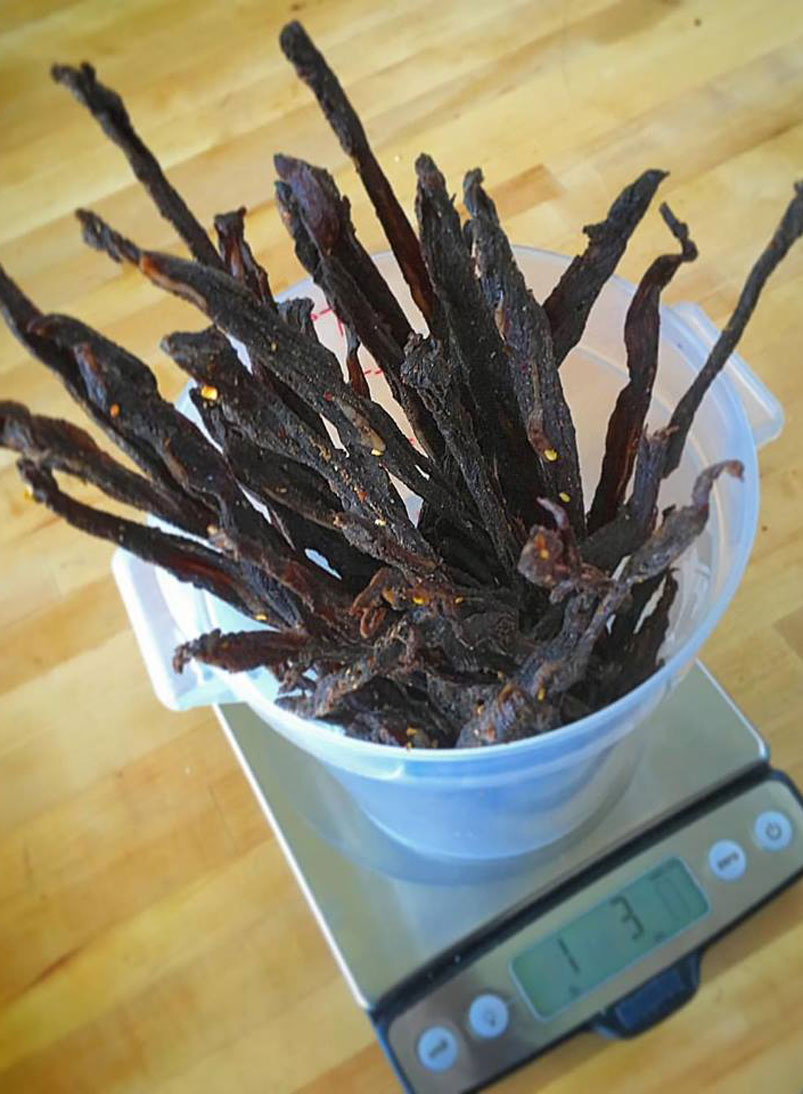 homemade beef jerky in a plastic container