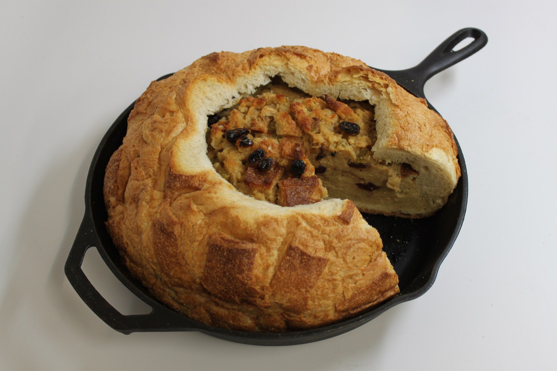 Spiced bread pudding in a cast-iron skillet on the set of Good Eats.