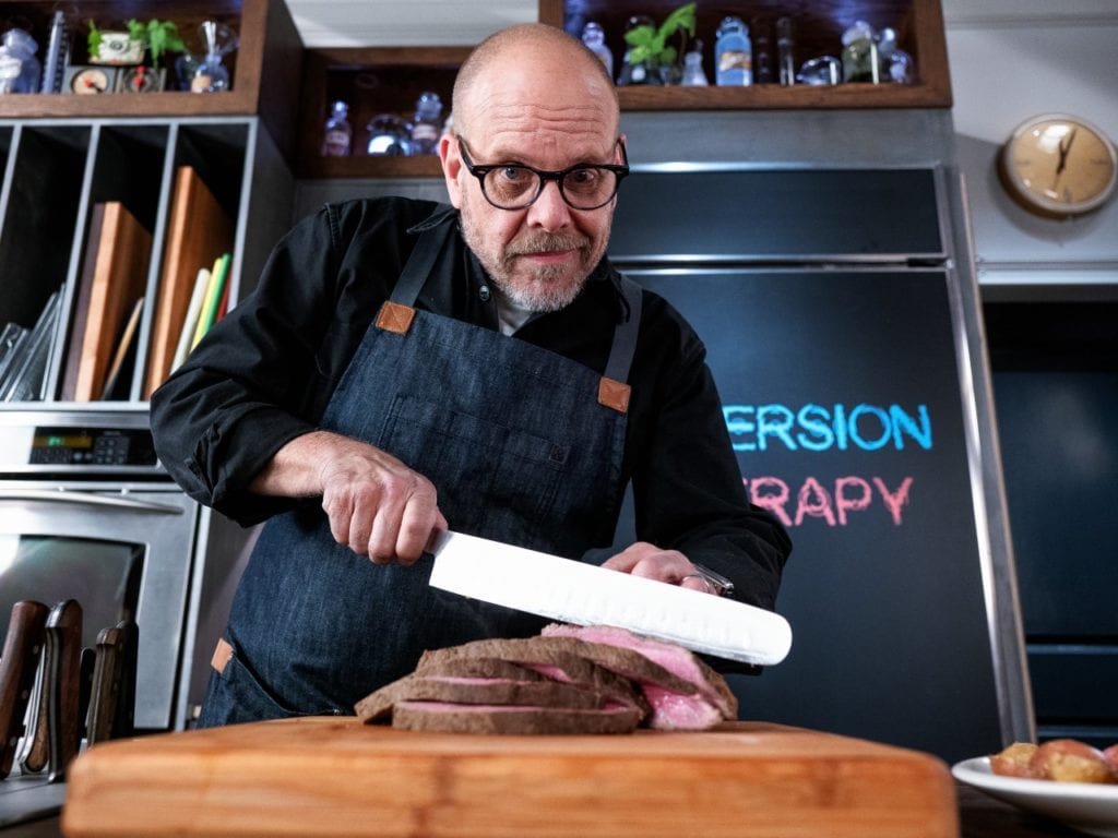 Alton Brown slicing rump roast cooked in an immersion circulator.