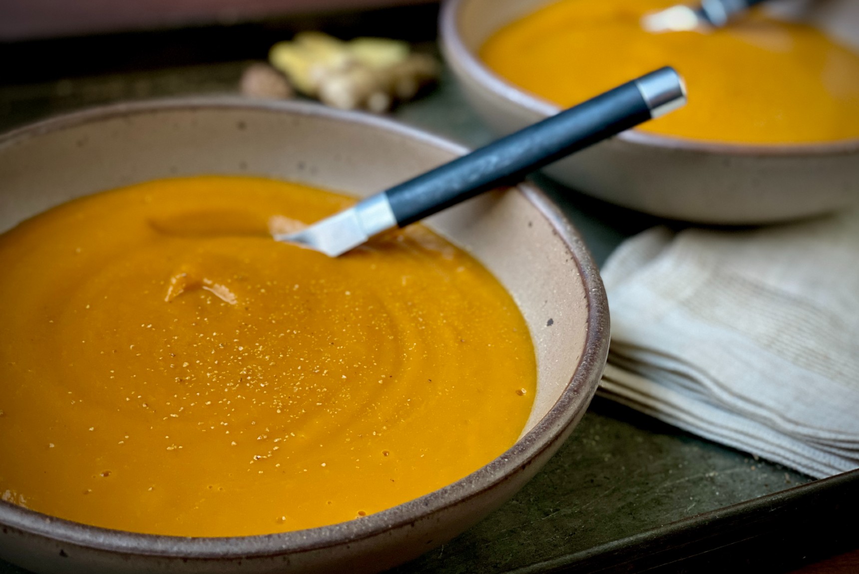 Two bowls of honey-ginger butternut squash soup.