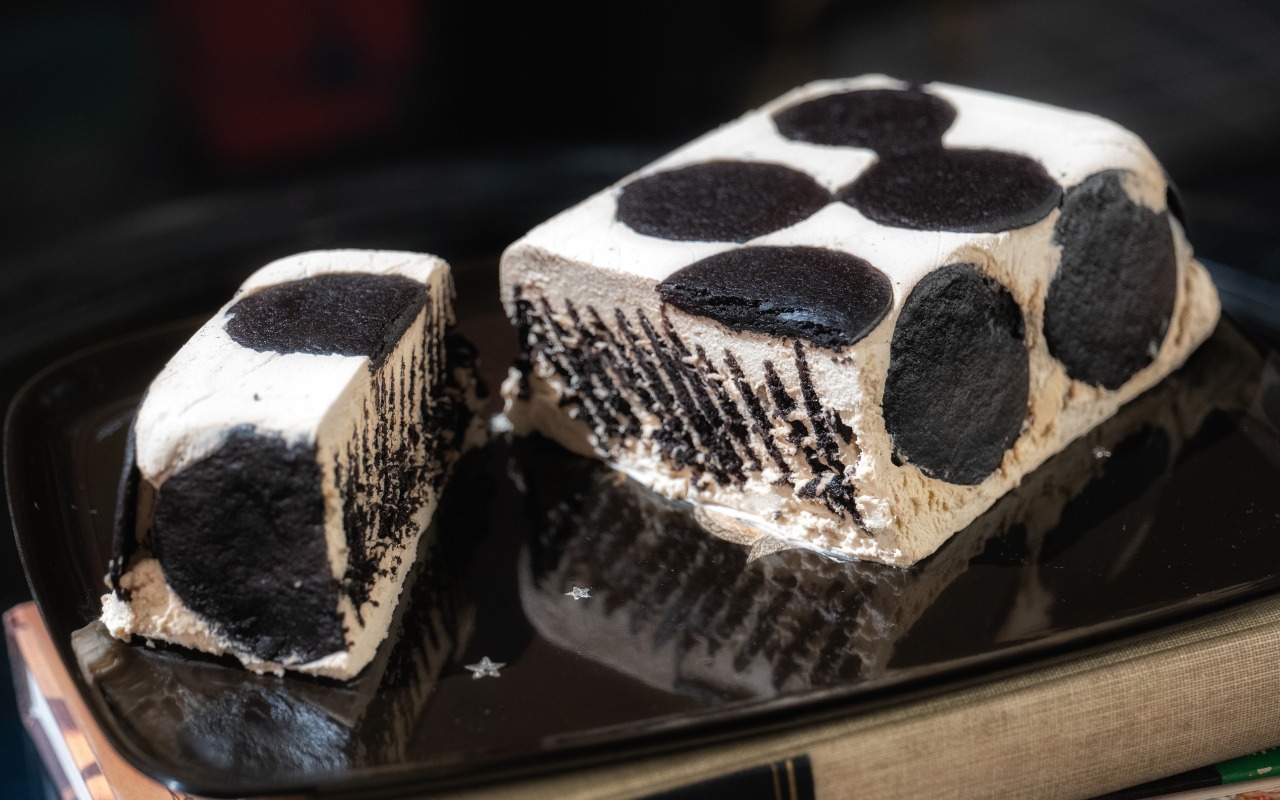 Chocolate mocha refrigerator cake on a black plate.