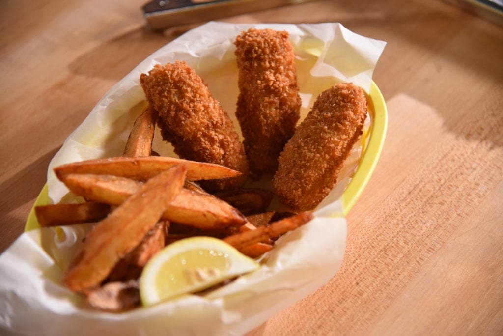 Beer-battered fish and chips in parchment paper-lined basket.