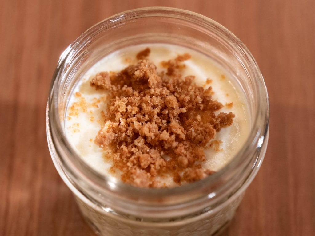 Immersion circulator cheesecake with graham cracker topping in a mini-mason jar.
