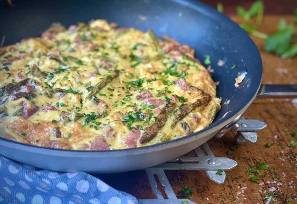 Ham and cheese frittata in a pan.