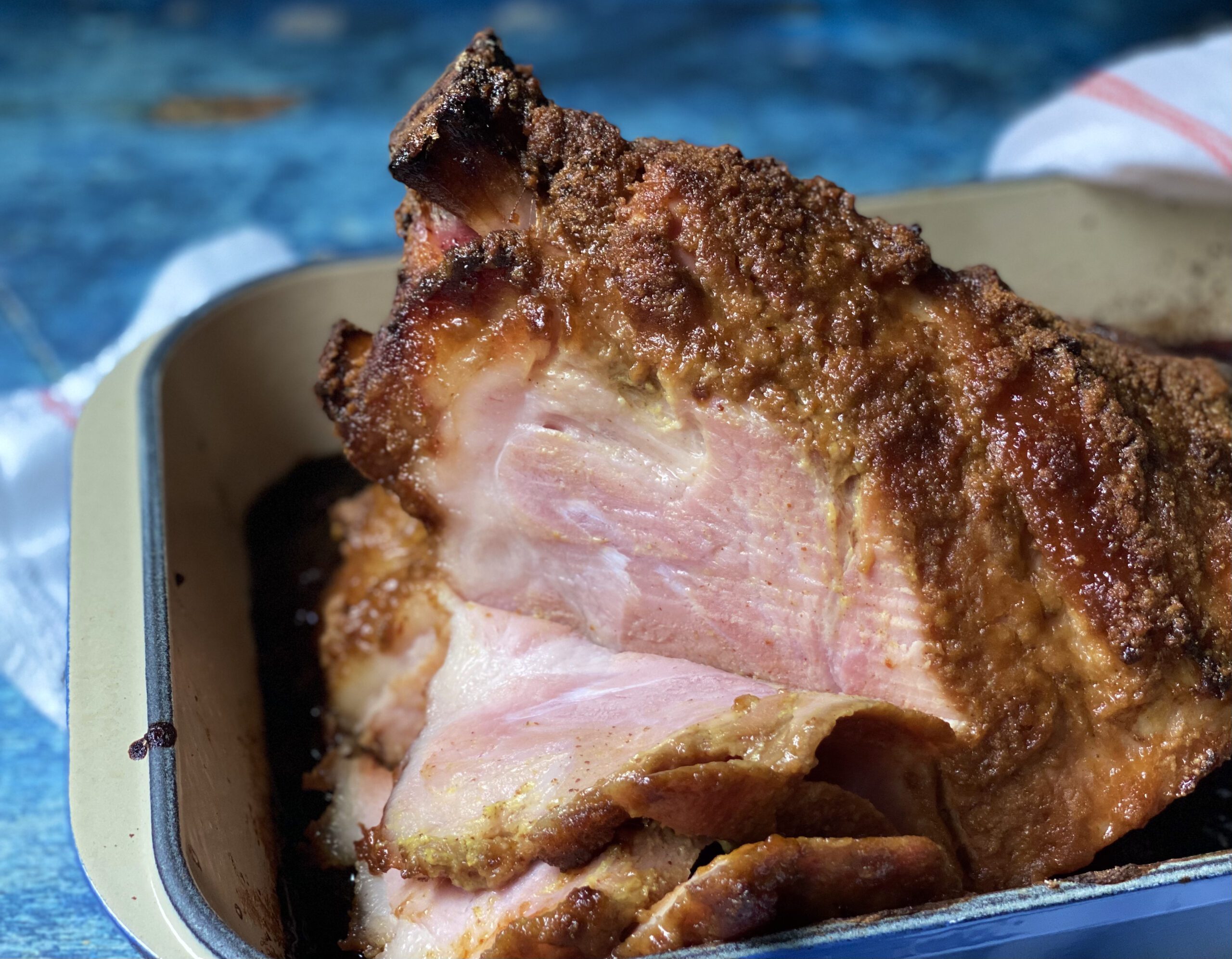 City ham with a crispy crust featuring brown mustard, bourbon, and gingersnap cookies, offering a flavorful twist on a classic dish.