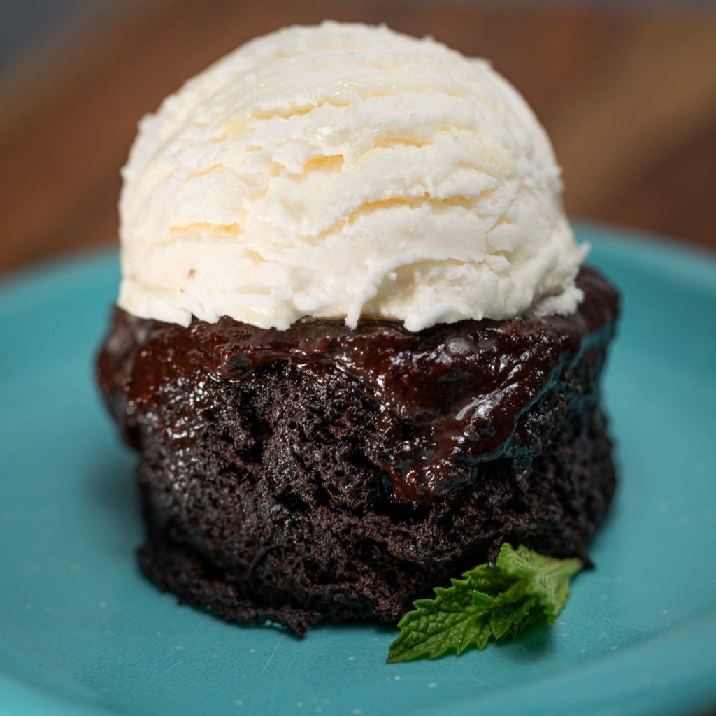 Midnight mug cake for 2 topped with a scoop of vanilla ice cream.