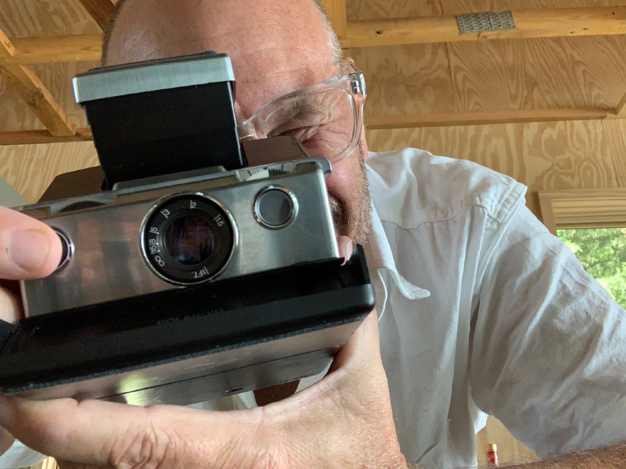 Alton Brown holding old fashioned camera