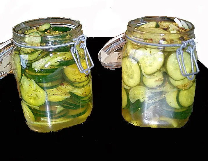 Bread and butter pickles from Alton Brown in two spring top jars.