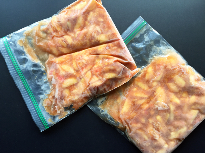 Frozen peaches in two 1-gallon plastic zip-top bags.