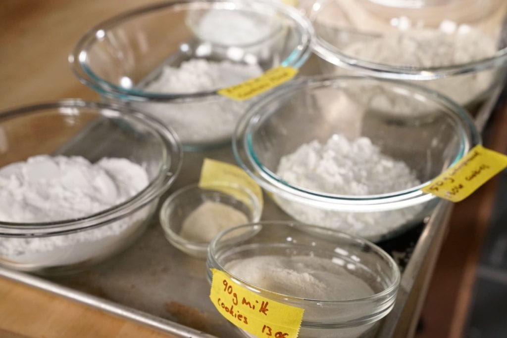 Gluten-free flour mix ingredients separated in glass bowls.