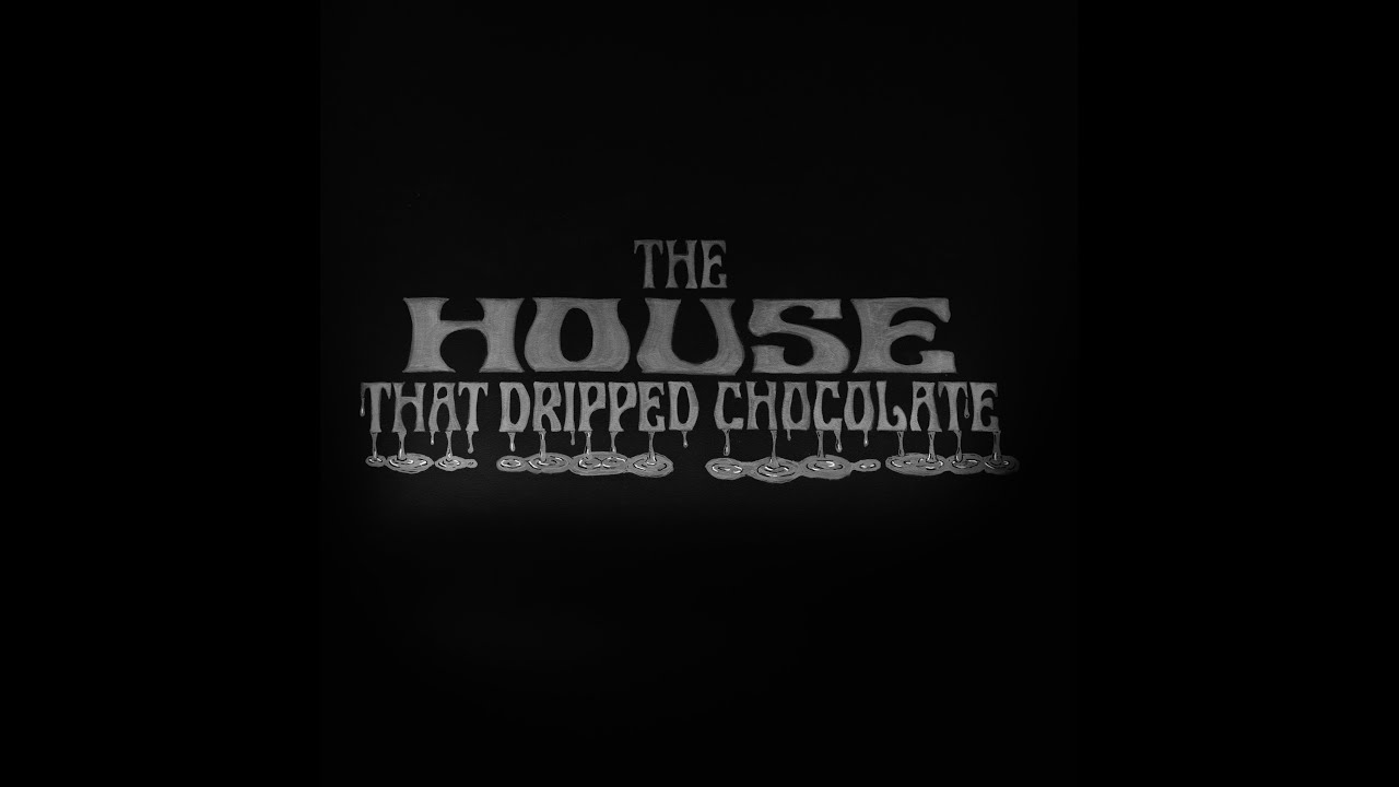 The House That Dripped Chocolate logo written in chalk on the set of Good Eats: The Return season 2.