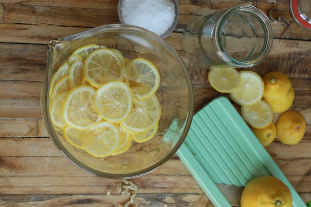 Preserved lemons sliced on a mandoline for preserved lemons-ade.