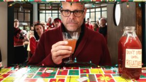 Alton Brown sips low-alcohol holiday coctail cranberry-apple shrub on the set of Good Eats: The Return.